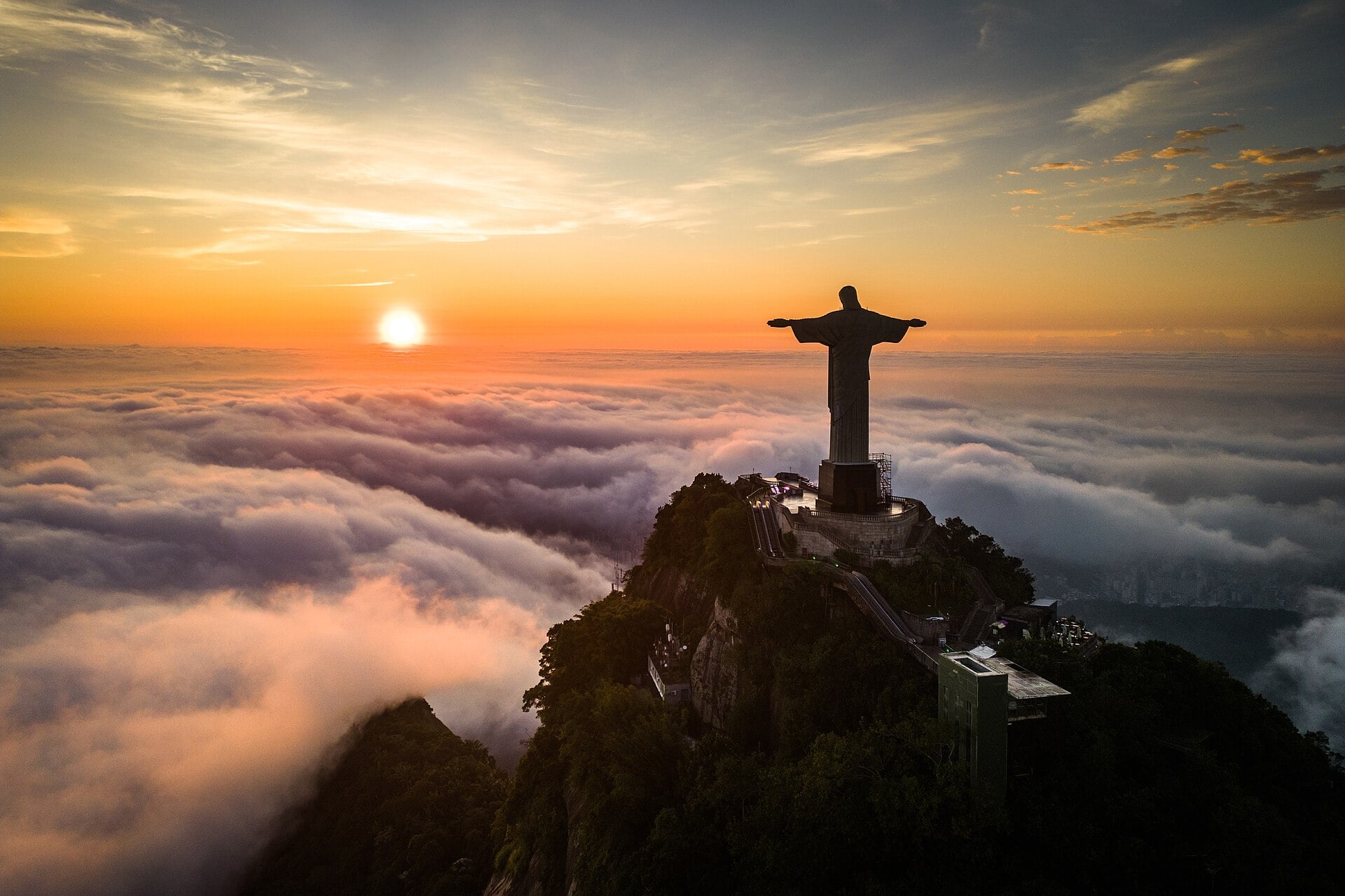 Cristo Redentor no alto do Corcovado acima das nuvens ao nascer do sol
